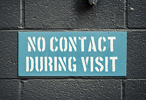 Prison sign that says No Contact During Visit